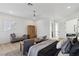 Spacious primary bedroom with a chaise lounge, light wood floors, and access to an ensuite bathroom at 4944 Spanish Heights Dr, Las Vegas, NV 89148
