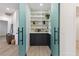Pantry featuring custom built-in shelves and stylish wallpaper at 4944 Spanish Heights Dr, Las Vegas, NV 89148