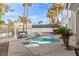 A tranquil pool area awaits, complete with lounge seating and mature palm trees at 4944 Spanish Heights Dr, Las Vegas, NV 89148