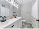 Dual sink vanity is the focal point in this bright bathroom with a decorative mirror accent above the toilet at 5045 Sock Hop Way, North Las Vegas, NV 89031