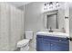 Bathroom featuring a shower with curtain, toilet and navy blue vanity at 5045 Sock Hop Way, North Las Vegas, NV 89031