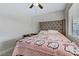 Bright bedroom featuring a ceiling fan, window, and a patterned bed at 5045 Sock Hop Way, North Las Vegas, NV 89031