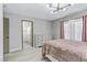 Bright bedroom features a light fixture and wood-look flooring, and connects to the ensuite bathroom at 5045 Sock Hop Way, North Las Vegas, NV 89031