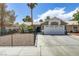 This exterior view showcases the front of a well-kept home with desert landscaping and fenced yard at 5045 Sock Hop Way, North Las Vegas, NV 89031