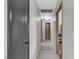 Bright hallway featuring neutral walls and floors, leading to doorways at the end at 5045 Sock Hop Way, North Las Vegas, NV 89031
