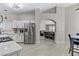 Open eat-in kitchen with modern stainless appliances, white cabinets, and adjoins the living room at 5045 Sock Hop Way, North Las Vegas, NV 89031