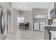 Eat-in kitchen with dining area, stainless appliances, laundry closet, and wood-look tile floors at 5045 Sock Hop Way, North Las Vegas, NV 89031