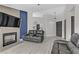 Open living space with sleek floors, gray accent walls, comfortable seating, and a modern fireplace at 5045 Sock Hop Way, North Las Vegas, NV 89031