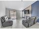 Comfortable living room boasts a fireplace, large windows, and stylish, neutral tones at 5045 Sock Hop Way, North Las Vegas, NV 89031