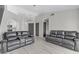 Open living area with wood-look tile flooring and comfortable seating at 5045 Sock Hop Way, North Las Vegas, NV 89031