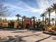 Inviting community center boasts lush landscaping, palm trees, arched entrance and covered portico at 5078 Rivedro St, Las Vegas, NV 89135