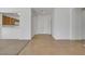 Bright foyer featuring neutral tile flooring, a double door coat closet, and access to the kitchen and dining areas at 5078 Rivedro St, Las Vegas, NV 89135