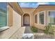 The front entrance features a covered arched entry with a double door, and a decorative rock garden at 5078 Rivedro St, Las Vegas, NV 89135