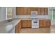 A view of the kitchen, featuring a double basin sink, a gas range, and wood cabinetry at 5078 Rivedro St, Las Vegas, NV 89135