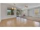 Bright living room with tile and carpet flooring, ceiling fan, and sliding glass doors to the outside patio at 5078 Rivedro St, Las Vegas, NV 89135