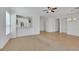 Open-concept living room featuring neutral walls, tile/carpet flooring, and abundant natural light at 5078 Rivedro St, Las Vegas, NV 89135