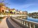 Picturesque view of community building reflecting on pond, with walking path and manicured landscaping at 5078 Rivedro St, Las Vegas, NV 89135