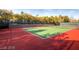 Well-maintained tennis court surrounded by trees and fencing, providing privacy and shade at 5078 Rivedro St, Las Vegas, NV 89135