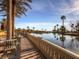 Relaxing view from patio along a serene waterfront, framed by towering palm trees and community buildings at 5078 Rivedro St, Las Vegas, NV 89135