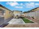 Well-maintained backyard featuring a patio, seating, grill, and artificial grass, ideal for outdoor living at 520 Blackbird Knoll Ct, North Las Vegas, NV 89084