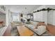 Open-concept living room with a modern kitchen, comfortable seating, and an inviting atmosphere for entertaining at 520 Blackbird Knoll Ct, North Las Vegas, NV 89084