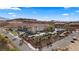 Expansive aerial showcases the charming resort-style condos nestled in a desert landscape with views of hills and palm trees at 555 Highland Dr # 203, Mesquite, NV 89027