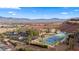 Scenic aerial shot displays a resort community offering a tennis court, pool, parking and gorgeous desert views at 555 Highland Dr # 203, Mesquite, NV 89027