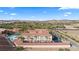 Scenic aerial view of resort condos with pool, tennis court, ample parking, all in a well-maintained desert community at 555 Highland Dr # 203, Mesquite, NV 89027