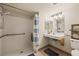 Accessible bathroom featuring grab bars, roll-in shower, and a floating vanity at 555 Highland Dr # 203, Mesquite, NV 89027