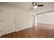 Spacious bedroom featuring wood-look flooring and a ceiling fan and multiple doors at 555 Highland Dr # 203, Mesquite, NV 89027