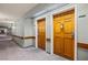 Hallway view of unit doors with carpeted floors and neutral wall paint at 555 Highland Dr # 203, Mesquite, NV 89027