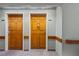 Hallway featuring two wooden doors with room numbers at 555 Highland Dr # 203, Mesquite, NV 89027