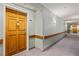 View of a well lit hallway with neutral walls, carpeted floors and handrails at 555 Highland Dr # 203, Mesquite, NV 89027