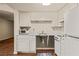 Bright kitchen with white cabinets and appliances and wood look flooring at 555 Highland Dr # 203, Mesquite, NV 89027