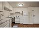 Bright kitchen with white cabinets and appliances with wood look flooring at 555 Highland Dr # 203, Mesquite, NV 89027