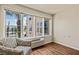 Bright room featuring a large window, chair, air conditioning unit, and wood-look floors at 555 Highland Dr # 203, Mesquite, NV 89027