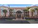 A ground level view of the resort's facade and arched entrance is lined with palm trees and lush landscape at 555 Highland Dr # 203, Mesquite, NV 89027