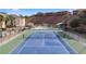 Brightly lit tennis court ready for a friendly match, with a pool and clubhouse providing additional resort-style amenities at 555 Highland Dr # 203, Mesquite, NV 89027