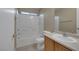 Bright bathroom features a white tub and shower combination, toilet, and vanity with sink at 5553 High Wager Way # 101, Las Vegas, NV 89122