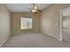 Carpeted bedroom featuring a window, neutral walls, and a ceiling fan at 5553 High Wager Way # 101, Las Vegas, NV 89122