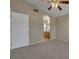 Neutral bedroom featuring a ceiling fan, plush carpet, and archway to the bathroom at 5553 High Wager Way # 101, Las Vegas, NV 89122