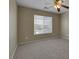 Spacious bedroom filled with natural light from the window, complemented by plush carpet and ceiling fan at 5553 High Wager Way # 101, Las Vegas, NV 89122