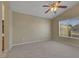 A spacious bedroom features neutral paint, carpeted floor, ceiling fan, and window at 5553 High Wager Way # 101, Las Vegas, NV 89122