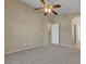 Neutral bedroom featuring plush carpet, ceiling fan, and a doorway into an adjoining room at 5553 High Wager Way # 101, Las Vegas, NV 89122