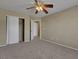 A simple bedroom offers plenty of space, neutral paint, carpeted floor and ceiling fan at 5553 High Wager Way # 101, Las Vegas, NV 89122