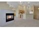 Inviting open-concept living space with fireplace and views of the kitchen at 5553 High Wager Way # 101, Las Vegas, NV 89122