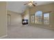 Spacious living room with neutral walls, new carpet and fireplace as a focal point at 5553 High Wager Way # 101, Las Vegas, NV 89122