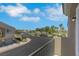 Balcony view of the street, surrounding homes, mature landscaping, and neighborhood parking at 5553 High Wager Way # 101, Las Vegas, NV 89122