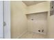 A simple utility room with tile flooring and shelf at 5553 High Wager Way # 101, Las Vegas, NV 89122