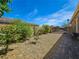 Low maintenance backyard with gravel, stone pavers, and greenery offers a versatile outdoor space at 6975 Hopi Summit Ct, Las Vegas, NV 89149